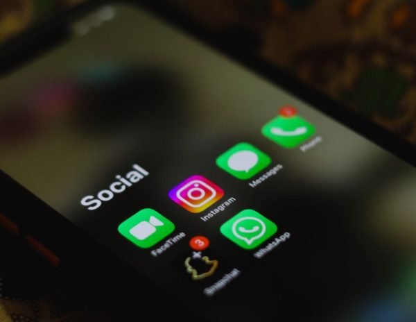 A close-up shot of smartphone displaying social media apps icons on screen.